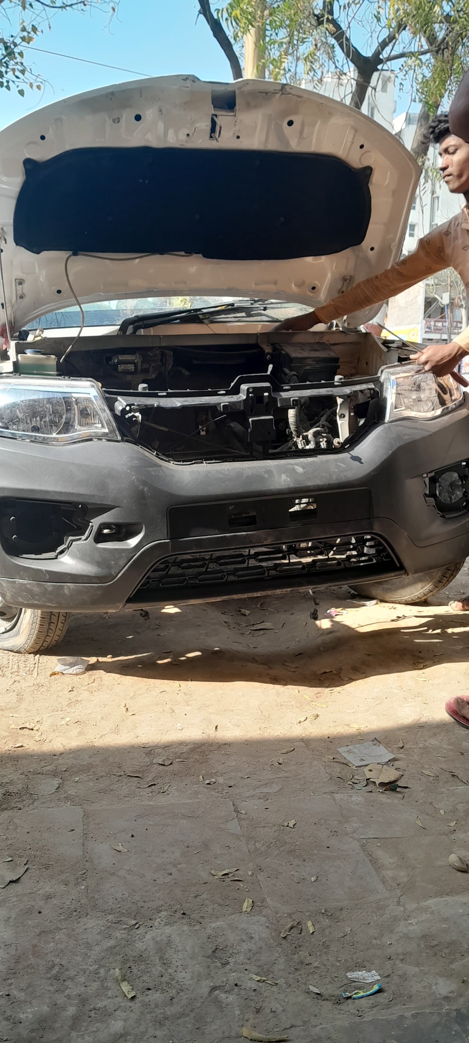 Car with its front bumper removed for body repair