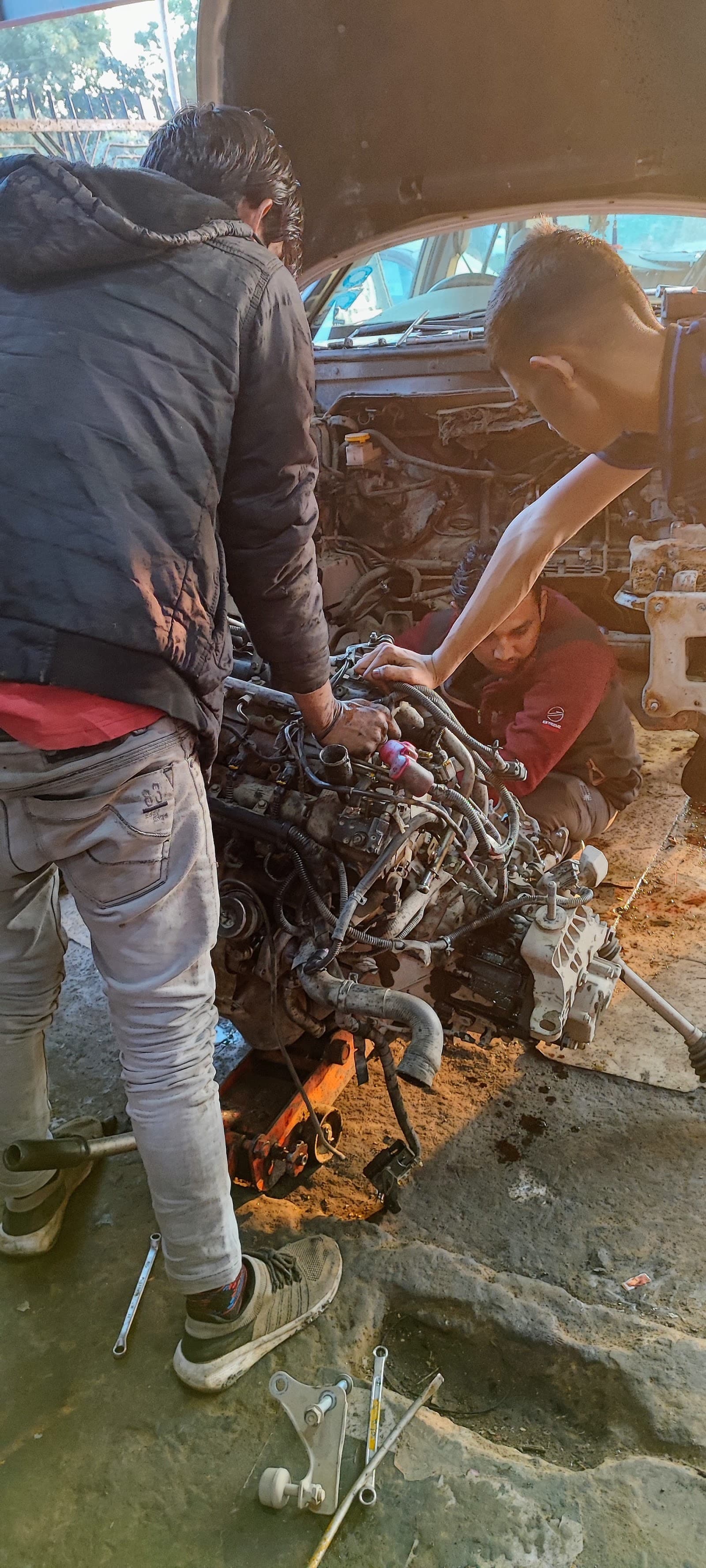 Mechanic repairing an engine inside the car