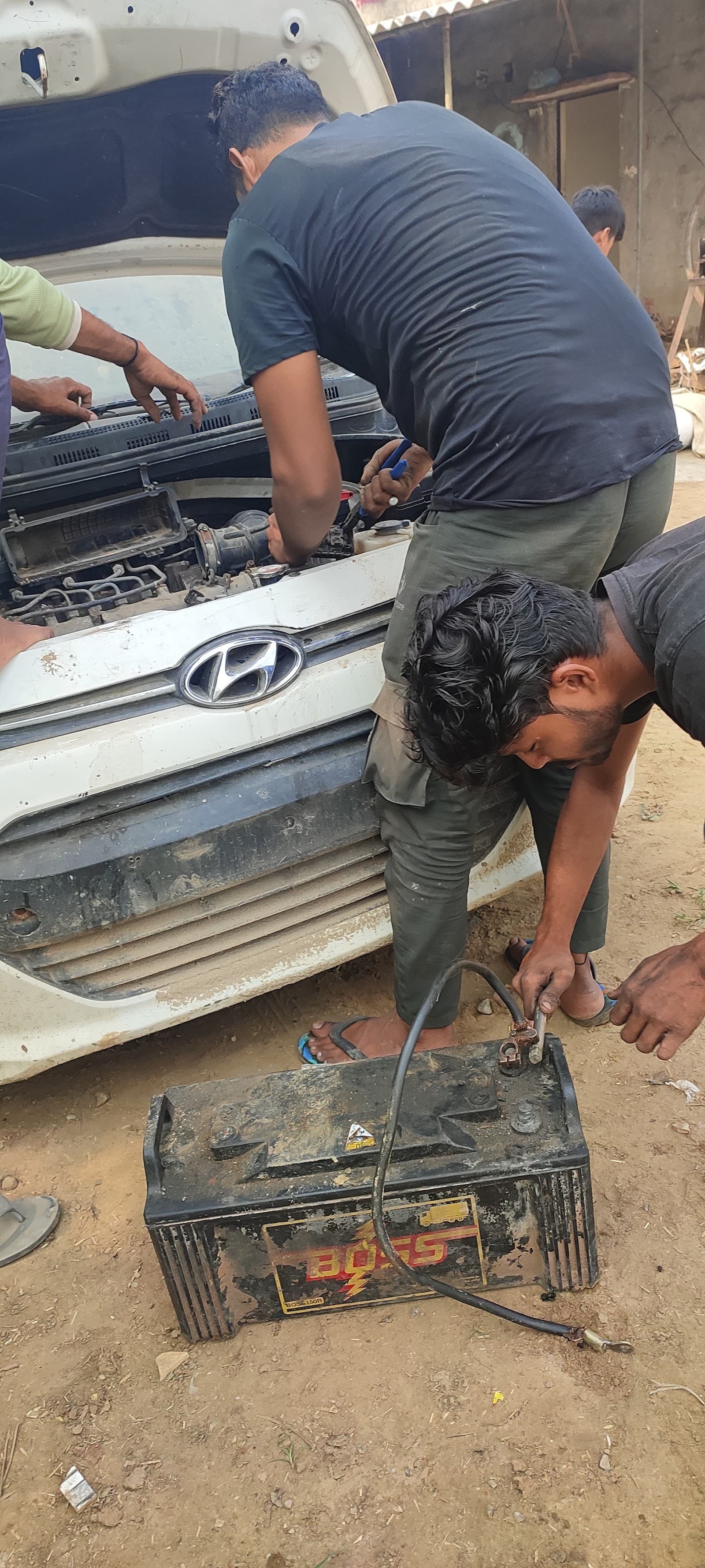 Mechanic working under the bonnet of a car